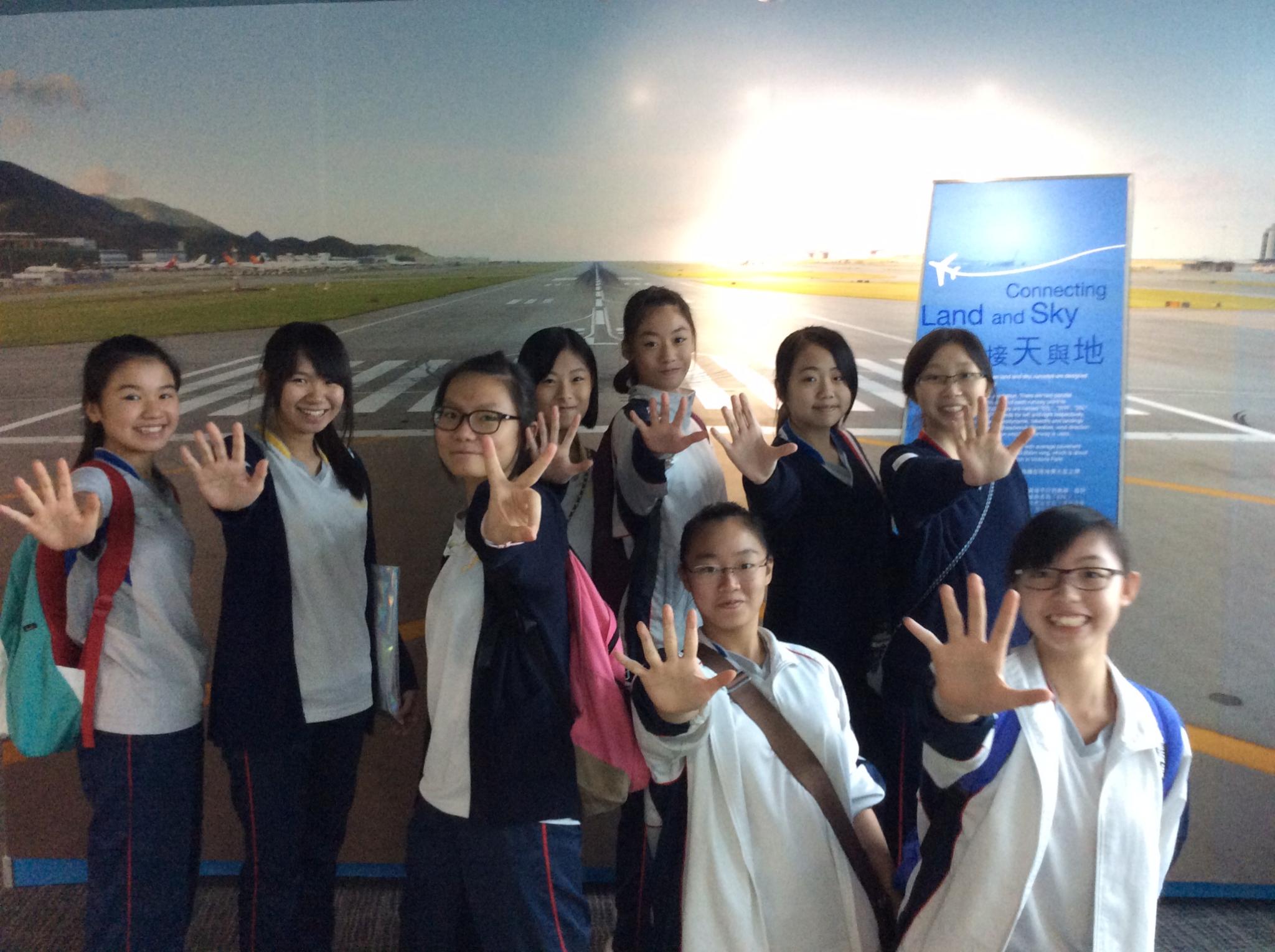 Students give a high-five to show their enthusiasm for their visit of the Civil Aviation Department. 