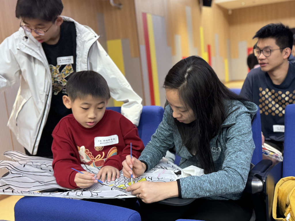Parents making a kite with their children for experiencing traditional craft. Parents making a kite with their children for experiencing traditional craft.