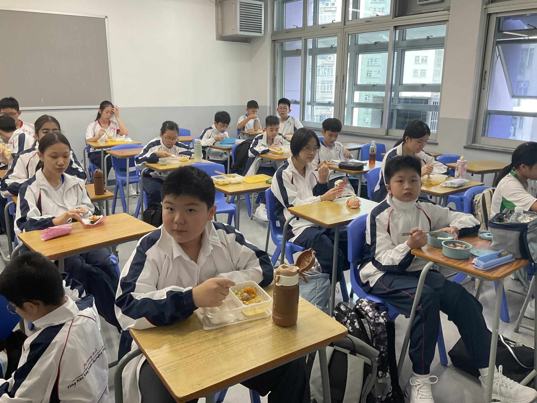 Students enjoy lunch at their desks in the classroom after a morning of activities. Students enjoy lunch at their desks in the classroom after a morning of activities.