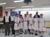 At the end of the competition, the two teams and their coaches are posing for a group photo. 