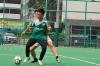 Jeffee Ng, one of the old boys, is trying to get the ball from Kan Chan, a current student. 