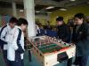 Students are playing table football game.