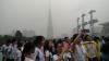 Students are taking photos of the modern architectural complex in Huacheng Square.