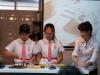 Two students are making the red bean paste for the sago dessert.