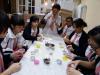 Students are putting the sago and red bean paste together to make the sago dessert.