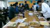 Students enjoy their food with their class teacher.