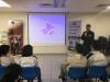A police dog trainer is giving a talk to our students.