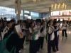 Students are focusing on the flight information board. 