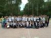 At the end of the English day camp, students and teachers are posing for a group photo. 