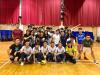 All the dodgeball players and alumni representatives are posing for a photo together.