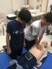 The student is learning how to do the Cardiopulmonary resuscitation (CPR).