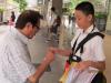 The student is giving a flag to a donor.