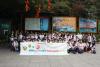 Students and teachers are posing for a group photo in Danxia Mountain