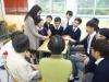 Class teacher is playing the game with students and the elderly.