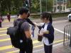 Students are selling flags to a family in a proper manner.