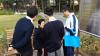 Students are sharing the community service information to the elderly.