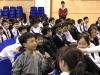 A student is trying to answer a question from the speaker.