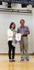 Ms. Lee Shuk Fan, head of Moral, Civic & National Education Committee was presenting the souvenir to Mr. Leung. 