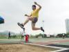 A student was trying his best in the Long Jump competition.