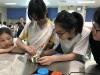 Students are shredding an orange peel to make dessert.