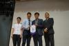 The Principal presents a pennant to the representatives of The Food and Environmental Hygiene Department.