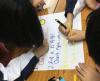 Students worked in pairs and wrote the class regulations on a piece of paper after discussion.