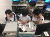 Students were building their own car under the supervision of the student helpers.