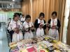 Students are reading their favourite books in the book fair.