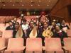 Members of the Chinese Orchestra are posing for a group photo.
