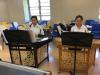 Two students are playing Yangqin together.
