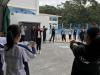Students were doing warm-up exercise before rock climbing.