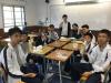Boys from class 2A are having lunch together with their soya milk treated by Ms. Siu.