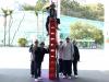 Student climbed on top of crates with the help of her teammates.