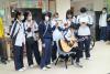 Students are singing to physically handicapped people.