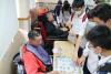 Students had a chess match with a physically handicapped person. 