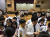 All students were lining up and waiting to taste the fruits.