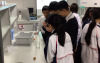Students were preparing the extraction solution for extracting DNA from strawberries later.