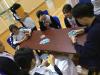 Students are concentrated on the card game.