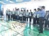 Students are listening attentively to the instructor explaining the aerial view of the Hong Kong international airport on the luminous glass floor.