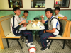 Students are pretending to "drink tea" in an old style Chinese restaurant.
