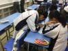Students worked in pairs and wrote the class regulations on a piece of paper after discussion. 