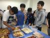 Students are sharing their food happily during the Christmas party. They all bring their own reusable utensils. 