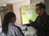 The teacher is giving guidelines to student.