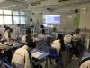 Students watch a video tour in the classroom.