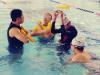 Participants listening to a swimming coach dutifully.