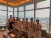 Students take a photo with the beautiful view of the city at the backdrop.