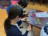 Students are creating beautiful Mandala Art at the booth.