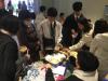 Students take materials from the booth with their parents.