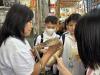 Students having close contact with the snake at Sher Wong Yip