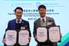 Dr. Jimmy Wong, Executive Director of the HKAGE, and Principal Wong exchange documents at the ceremony.